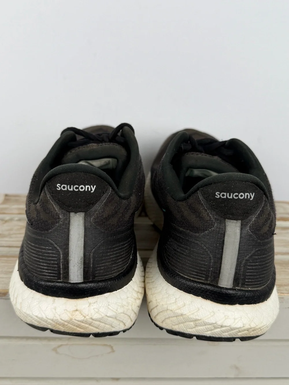 Saucony Triumph 19 running shoes in black an white with subtle teal accents 10.5
